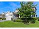 Well-maintained home with a blooming tree, lush lawn, and manicured landscaping at 3467 Buoy Cir, Winter Garden, FL 34787