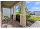 Covered front porch with brick flooring, columns, landscaping, and seating at 3467 Buoy Cir, Winter Garden, FL 34787