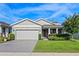 Charming single-story home featuring a manicured front yard, attached two-car garage, and inviting entryway at 3467 Buoy Cir, Winter Garden, FL 34787