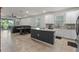 Bright and modern kitchen featuring white cabinets, stainless steel appliances, and a large island with seating at 3467 Buoy Cir, Winter Garden, FL 34787