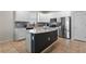Bright, modern kitchen featuring stainless steel appliances, an island, and ample counter space at 3467 Buoy Cir, Winter Garden, FL 34787