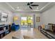 Bright living room with a ceiling fan, sliding glass doors to lanai, and comfortable furniture at 3467 Buoy Cir, Winter Garden, FL 34787