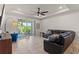 Spacious living room with tile floors, ceiling fan, recessed lighting, and sliding glass doors to a patio at 3467 Buoy Cir, Winter Garden, FL 34787