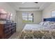 Bedroom featuring a tray ceiling, view and large dresser at 3467 Buoy Cir, Winter Garden, FL 34787