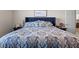 Bedroom features a large, comfortable bed with blue headboard and decorative paisley bedding at 3467 Buoy Cir, Winter Garden, FL 34787