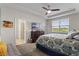 This main bedroom features a tray ceiling, TV, dresser, and ensuite bathroom at 3467 Buoy Cir, Winter Garden, FL 34787