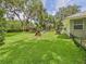 Expansive backyard with mature trees, a gazebo, outdoor seating, and a green lawn at 4207 Bair Ave, Fruitland Park, FL 34731