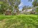 Sprawling backyard with a gazebo, green lawn, mature trees, and the house in the background at 4207 Bair Ave, Fruitland Park, FL 34731