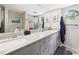 Bathroom features a double sink vanity with granite counters and ample storage space at 4207 Bair Ave, Fruitland Park, FL 34731