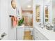 Bathroom with updated tile surround, white cabinets and a large vanity at 4207 Bair Ave, Fruitland Park, FL 34731