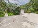 Well-maintained home exterior featuring a two-car garage, mature landscaping, and a concrete driveway at 4207 Bair Ave, Fruitland Park, FL 34731