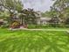Charming single-story home with a well-manicured lawn and lush landscaping, creating great curb appeal at 4207 Bair Ave, Fruitland Park, FL 34731