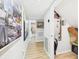 Hallway with wood-look flooring, white trim, and views to the bathroom at 4207 Bair Ave, Fruitland Park, FL 34731