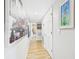 Hallway featuring neutral walls, wood-look floors, and artwork on display at 4207 Bair Ave, Fruitland Park, FL 34731