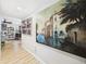 Hallway with wood floors and vibrant artwork at 4207 Bair Ave, Fruitland Park, FL 34731