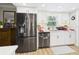 Well-lit kitchen featuring stainless steel appliances and white cabinetry at 4207 Bair Ave, Fruitland Park, FL 34731