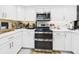 Modern kitchen with stainless steel appliances and white countertops at 4207 Bair Ave, Fruitland Park, FL 34731