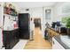 Open laundry room with storage cabinets and a view to the dining area at 4207 Bair Ave, Fruitland Park, FL 34731