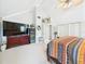 Bright and spacious main bedroom with tv, vaulted ceiling, and ceiling fan at 4207 Bair Ave, Fruitland Park, FL 34731