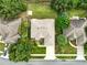 Aerial view showcases the home's layout, landscaped yard, and proximity to neighboring houses and street at 4401 Abaco Dr, Tavares, FL 32778