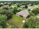 An aerial view of the home and its surroundings shows a spacious backyard and mature trees in a quiet neighborhood at 4401 Abaco Dr, Tavares, FL 32778
