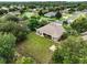 Aerial view of a home with a large, well-manicured backyard, mature trees and lush landscaping at 4401 Abaco Dr, Tavares, FL 32778