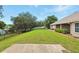 Expansive backyard featuring a well-manicured lawn, privacy fence, and patio area, ideal for outdoor entertaining at 4401 Abaco Dr, Tavares, FL 32778