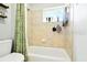 Bathroom featuring a tiled shower/tub and a window allowing for natural light and ventilation at 4401 Abaco Dr, Tavares, FL 32778