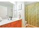 Bathroom with orange vanity, marble countertop, and decorative artwork at 4401 Abaco Dr, Tavares, FL 32778
