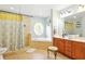 Bright bathroom with a separate shower, a soaking tub with unique round window, and dual vanity at 4401 Abaco Dr, Tavares, FL 32778