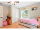 Well-lit bedroom with closet, hardwood floors, a twin bed, and a big window at 4401 Abaco Dr, Tavares, FL 32778