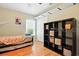 Bedroom with hardwood floors, a daybed, large shelving unit, and natural light from the window at 4401 Abaco Dr, Tavares, FL 32778