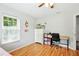 Comfortable bedroom with hardwood floors, ceiling fan, and lots of natural light from the large windows at 4401 Abaco Dr, Tavares, FL 32778