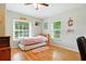 Inviting bedroom with hardwood floors, a trundle bed, and bright natural light from the windows at 4401 Abaco Dr, Tavares, FL 32778