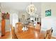 Bright formal dining room with hardwood floors and ornate chandelier, great for Gathering meals at 4401 Abaco Dr, Tavares, FL 32778