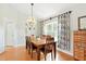 Dining room with hardwood floors, chandelier, and curtains, creating an inviting space at 4401 Abaco Dr, Tavares, FL 32778