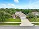 A beautiful home with a well-manicured lawn, mature landscaping, and a paved driveway at 4401 Abaco Dr, Tavares, FL 32778