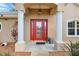 Home featuring a red front door framed by classic white columns on an inviting porch at 4401 Abaco Dr, Tavares, FL 32778