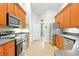 Well-lit kitchen featuring stainless steel appliances and ample cabinet space at 4401 Abaco Dr, Tavares, FL 32778