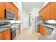 Modern kitchen with stainless steel appliances, tile floors, granite counters, and plenty of cabinet space at 4401 Abaco Dr, Tavares, FL 32778