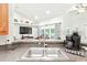 Galley kitchen with granite countertops and view into living space at 4401 Abaco Dr, Tavares, FL 32778