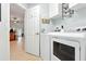 Bright laundry room with modern washer and dryer, cabinets, and laundry themed decorations at 4401 Abaco Dr, Tavares, FL 32778