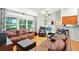 Living room with hardwood floors, comfortable leather furniture, large windows and high ceilings at 4401 Abaco Dr, Tavares, FL 32778