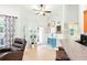 Bright living room with ceiling fan, lots of natural light and doors leading to the outdoors at 4401 Abaco Dr, Tavares, FL 32778