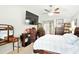 Large main bedroom with en-suite bath, vaulted ceilings, large TV, and ample natural light at 4401 Abaco Dr, Tavares, FL 32778