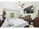 A spacious main bedroom featuring vaulted ceiling, large TV, and bay windows with lots of natural light at 4401 Abaco Dr, Tavares, FL 32778