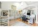 Home office featuring shelving units, desk, and hardwood flooring at 4401 Abaco Dr, Tavares, FL 32778