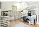 Bright office space with a grid wall unit, modern desk, and gray rug on light-colored floor at 4401 Abaco Dr, Tavares, FL 32778