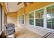Relaxing covered patio with string lights, grill, and views of the fenced backyard and lush landscaping at 4401 Abaco Dr, Tavares, FL 32778