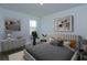 Cozy bedroom with neutral tones, a comfortable bed, decorative pillows, and natural light from a window at 5002 Abigail Dr, Lake Wales, FL 33859